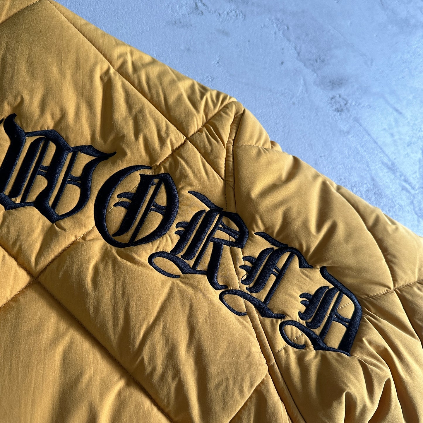 Corteiz Olde English Quilted Bomber Jacket Yellow