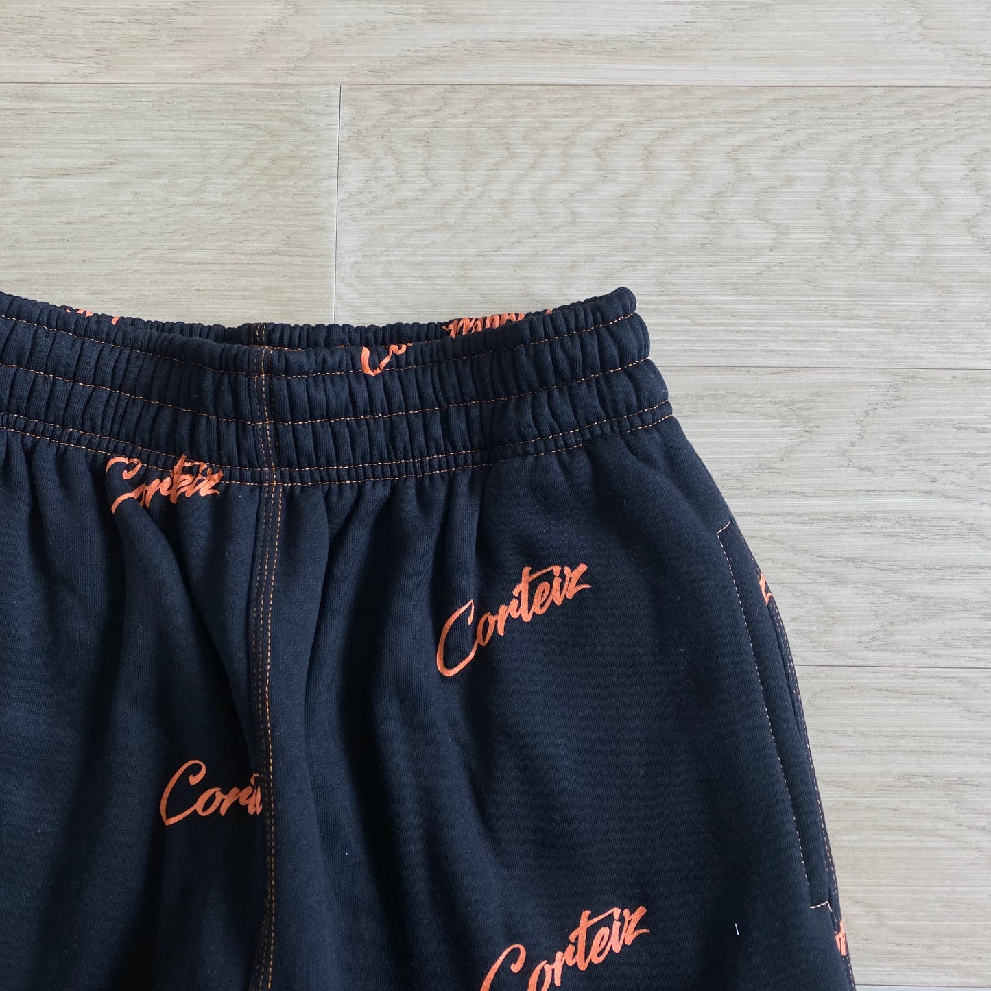 Corteiz All Over Print Joggers Black Orange